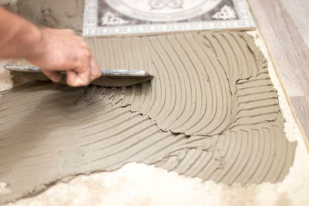 the master puts the tile on the floor