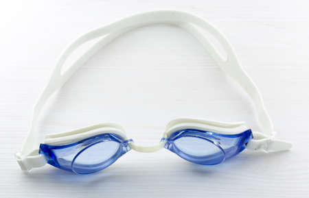 Floating underwater glasses on white table