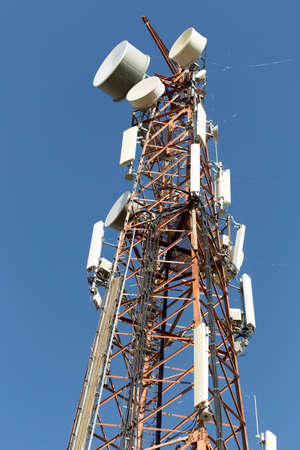 Telecommunication tower on blue sky clouds background,Tower poles and wireless telephone antennas