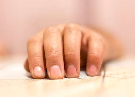 the man laid his hand on the tableの写真素材