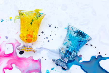 colored paints on a glass beakerの写真素材