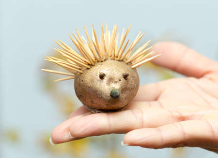 in the hand of the hedgehog, handmade from the autumn theme for the kindergartenの写真素材