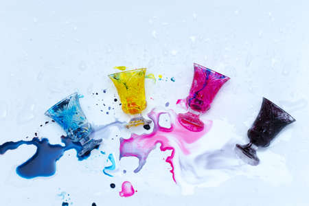 colored paints on a glass beakerの写真素材