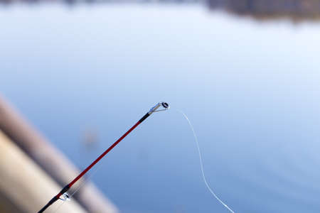 fishing rod on the river backgroundの写真素材