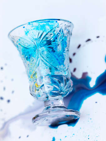 colored paints on a glass beakerの写真素材