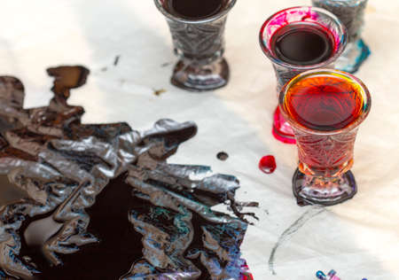 colored paints on a glass beakerの写真素材