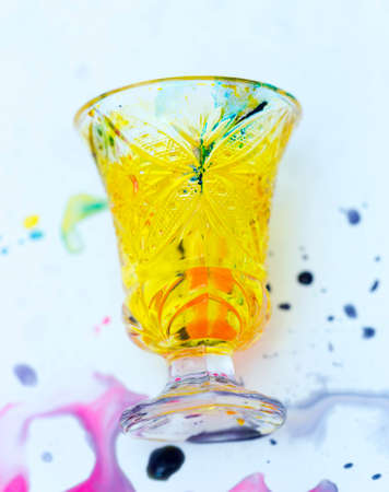 colored paints on a glass beakerの写真素材