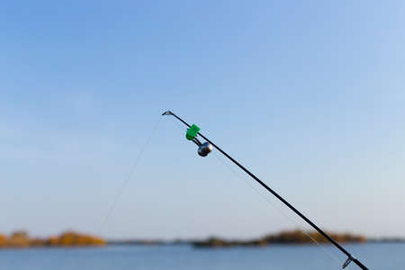 fishing rod on the river backgroundの写真素材