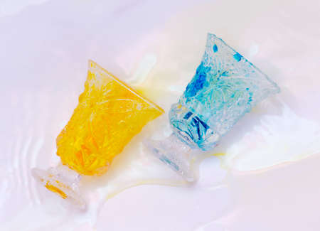 colored paints on a glass beakerの写真素材