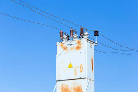 Electrical transformer against the blue sky backgroundの写真素材