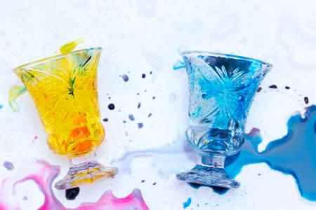 colored paints on a glass beakerの写真素材