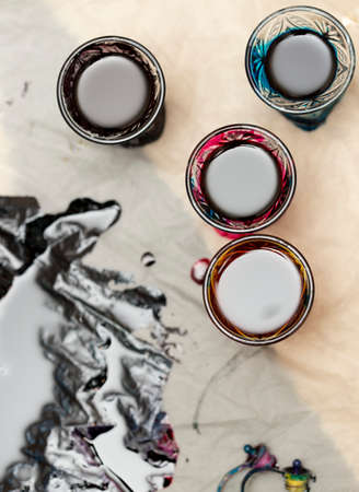 colored paints on a glass beakerの写真素材