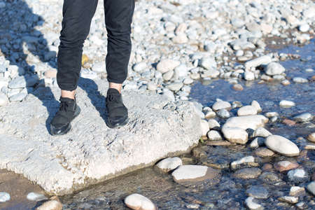A man standing on the rock near the waterの写真素材