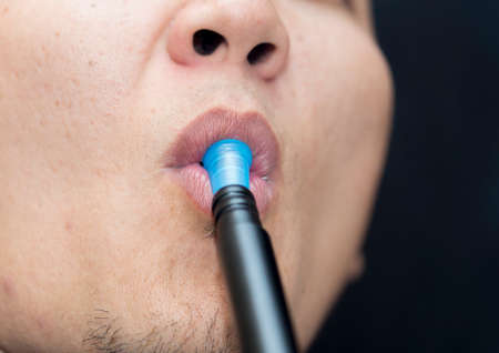 smoke hookah from the mouth of a manの写真素材