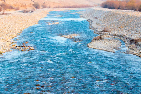 a stream of mountain water on a river with stones