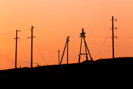 set of electric poles at sunset