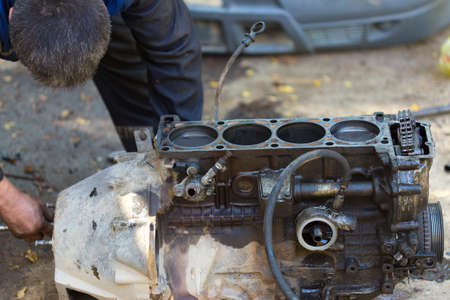 worker repairs the car engine
