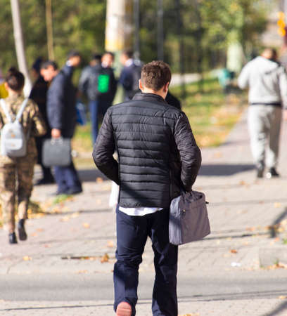 people walk on the sidewalk, the city