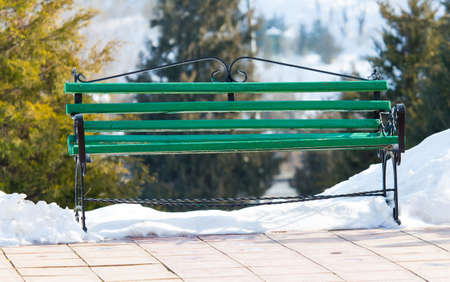 Green bench in the park in winter. Snow in the parkの写真素材