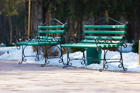 Green bench in the park in winter. Snow in the parkの写真素材