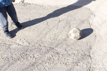 children play ball on the streetの写真素材