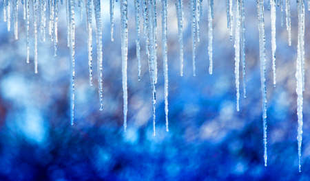 Icicles hanging from the roof or pipes in winterの写真素材