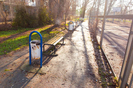 bench and urn in the courtyard of tall housesの写真素材
