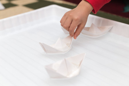 children playing on a paper boatの写真素材