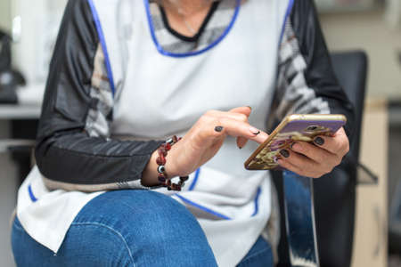 woman sitting with smartphone
