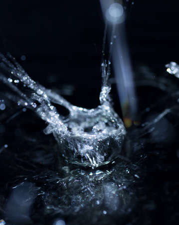 crown formed by a water spray on a black background