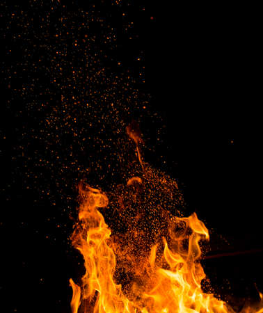 Flame of fire with sparks on a black background