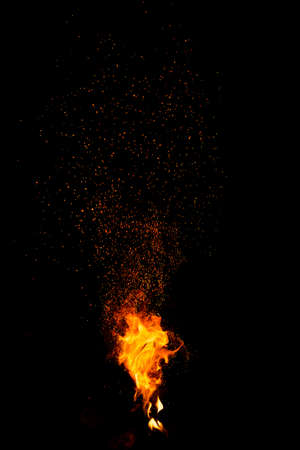 Flame of fire with sparks on a black background