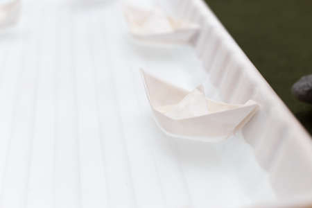 paper boat on waterの写真素材