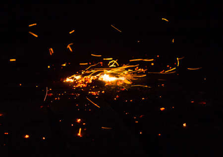 Flame of fire with sparks on a black background