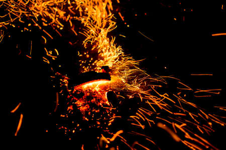 Flame of fire with sparks on a black background