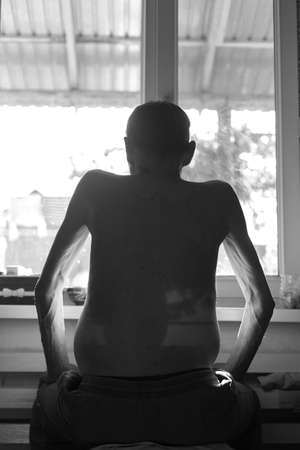 ascites in a person sitting near the windowsの写真素材