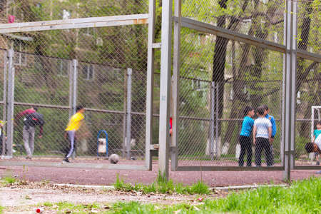 children play football in a mini stadiumの写真素材