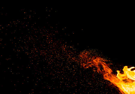 Flame of fire with sparks on a black backgroundの写真素材