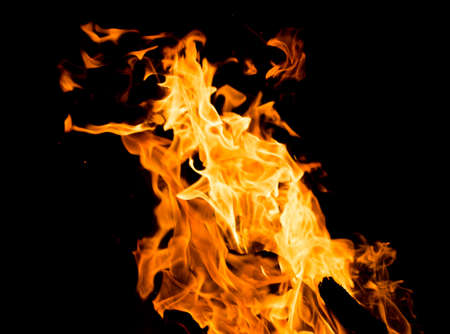 Flame of fire with sparks on a black backgroundの写真素材