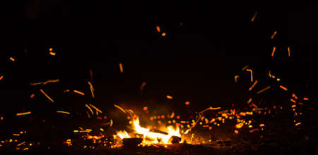 Flame of fire with sparks on a black backgroundの写真素材
