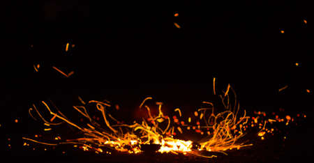 Flame of fire with sparks on a black backgroundの写真素材