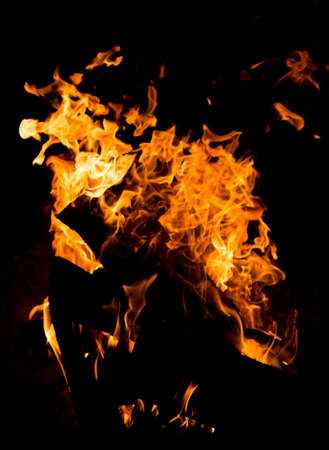 Flame of fire with sparks on a black backgroundの写真素材