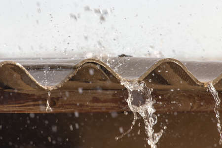 storm rain on the roof of the houseの写真素材