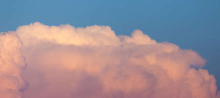 Magnificent colorful clouds in the evening sky. Bright, pink clouds in the sky at sunset. Beautiful...