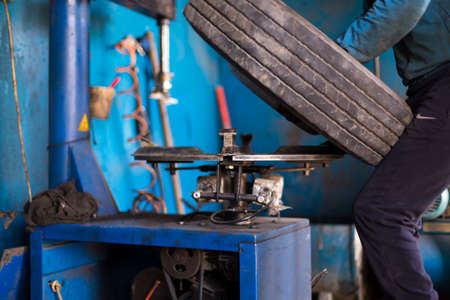 engineer balancing car wheel on balancer in workshopの写真素材