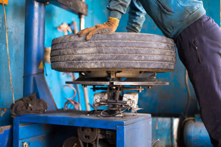 engineer balancing car wheel on balancer in workshopの写真素材