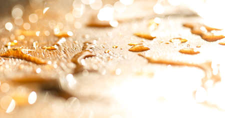 background bokeh, a drop of water golden flowers during sunsetの写真素材