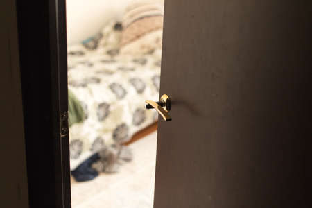 Half open door of a hotel bedroom or apartmentの写真素材