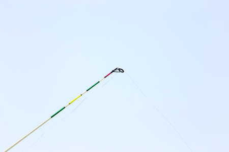 Fishing with a fishing rod on the river bankの写真素材