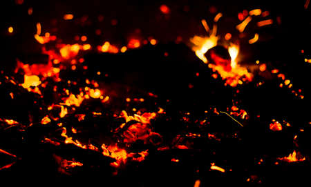 Flame of fire with sparks on a black backgroundの写真素材